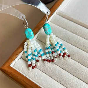 Detailed view of Tibetan retro ethnic style turquoise beaded earrings with pearl accents