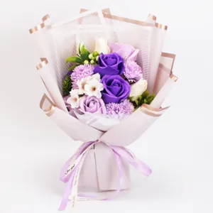 Close up view of purple soap rose bouquet detail with delicate gift wrapping ribbon.