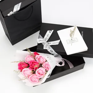Close-up of 9 artificial soap roses in a black gift box with a greeting card.
