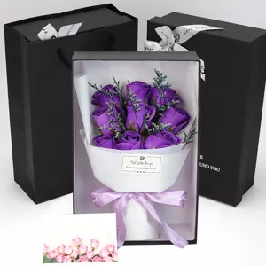 Close-up of nine purple soap roses in an elegant black gift box with matching gift bag