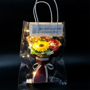 Graduation gift sunflower bouquet in a clear gift bag with warm LED fairy lights.