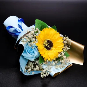 Mini graduation bouquet featuring yellow sunflower, blue soap rose and baby's breath flowers.
