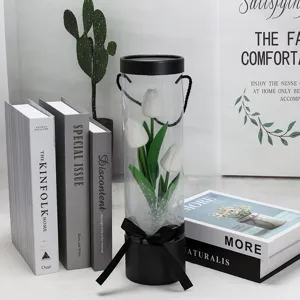 Transparent PVC cylinder box with white artificial tulips, elegant home decor gift item.