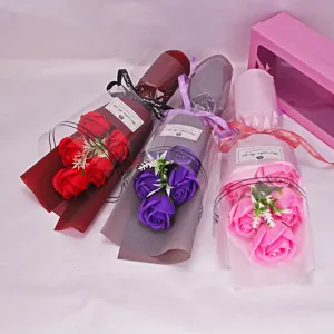 Detailed shot of beautifully wrapped artificial soap rose bouquets in vibrant red, purple and pink colors.