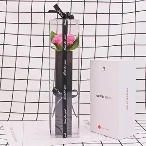 Single pink soap carnation flower in a transparent PVC gift box with decorative ribbon