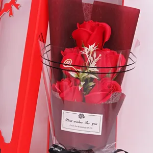 Close-up detail of romantic red soap rose bouquet with elegant dark wrapping and gift ribbon.