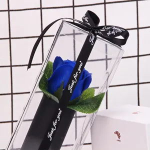 Detail view of a blue rose soap flower in a clear PVC box with a black ribbon.