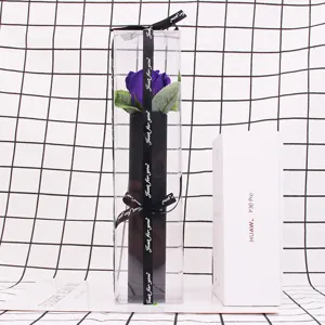 Detailed view of a single purple soap rose in a tall transparent PVC gift box