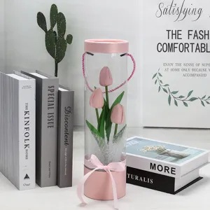 Transparent PVC cylinder gift box with pink artificial tulips and bowknot for home decor.