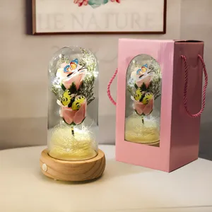 Détail d'une rose rose éternelle sous cloche de verre avec LED et boîte cadeau.