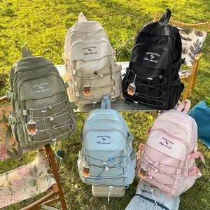 Group view of large capacity minimalist backpacks in five different colors outdoors.