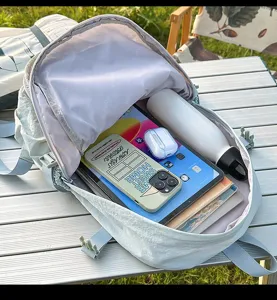 Detail shot of a light blue high-capacity backpack showing ample interior storage