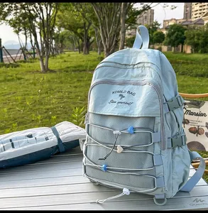 Detail shot of a minimalist light blue backpack featuring decorative colorful heart drawstrings