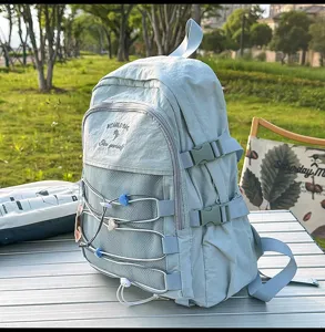 Detailed side view of a large mint green Japanese style backpack on a camping table