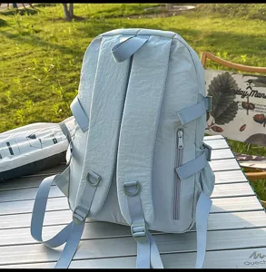 Back view of a lightweight light blue outdoor backpack with adjustable straps