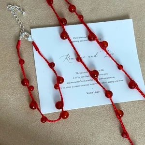 Hand-woven red agate beads on red cord necklace detail macro view 80-100 chars