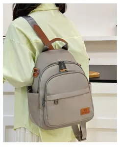 Casual minimalist nylon backpack for daily school and travel use with multiple pockets.