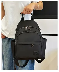 Black casual school backpack detail view, featuring multiple practical functional zipper pockets.