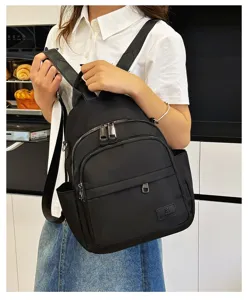 Casual black nylon backpack for women, featuring multiple zipper pockets and comfortable straps.
