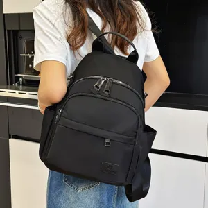 Casual black backpack for women and men, stylish multi-pocket school bag for daily use.