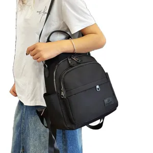 Casual black nylon backpack for women with multi-pocket design and comfortable straps.