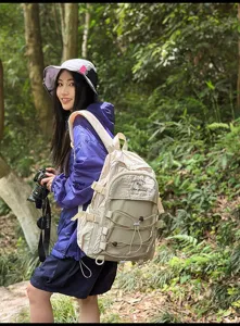 Lifestyle detail of a beige large-capacity outdoor backpack in a forest setting