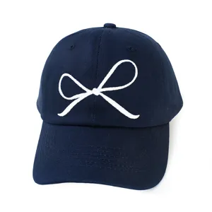 Nahaufnahme der dunkelblauen Baseballkappe mit eleganter weißer Schleifenbestickung.