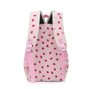 Detailed back view of a pink girls' backpack featuring red strawberry patterns and straps