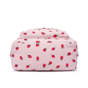 Detailed base view of this pink corduroy backpack featuring red strawberry prints