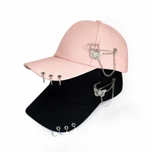Women fashion baseball cap with metal rings and butterfly chain design for summer sun protection.