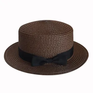 Close-up of brown straw boater hat with black ribbon bow, detailed woven texture summer sun hat.