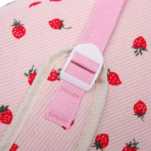 Macro detail of pink corduroy strawberry print backpack strap and buckle
