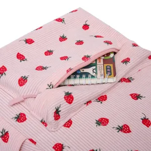 Close-up of strawberry print corduroy backpack showing zipper pocket detail