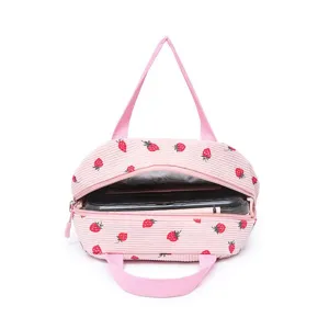 Detailed view of pink corduroy strawberry lunch bag with insulated lining