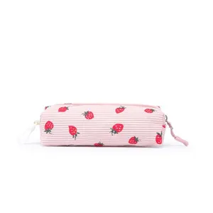 Detail shot of a pink corduroy pencil case with cute strawberry print and side clip.