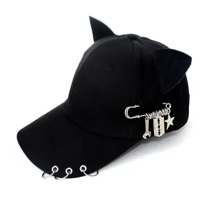 Black cat ear baseball cap with metal rings and punk safety pin charm for street style.