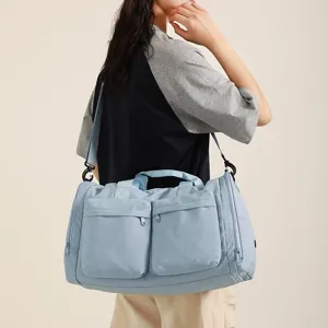 Vue détaillée du grand sac de sport bleu avec bandoulière réglable et poches avant.