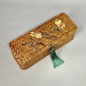 Detailed texture of handwoven seagrass storage box with elegant floral embroidery
