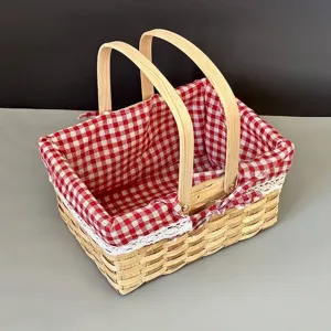 Detail of handwoven picnic basket with red checkered fabric lining and lace trim.