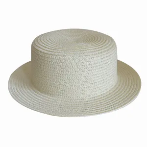 Detailed view of the woven straw texture on this classic flat-top boater hat for summer sun.