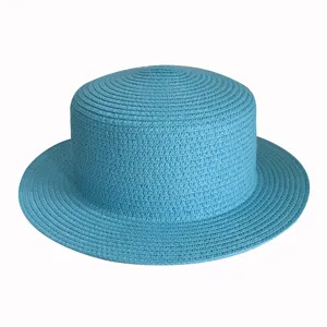 Close-up detail of the breathable blue flat top straw hat, perfect summer beach sun protection.