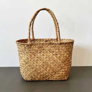 Close-up detail of a handmade seagrass woven basket showing natural straw texture