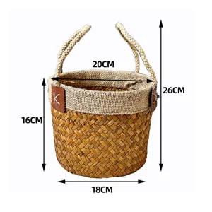 Handmade seagrass woven storage basket with handles and leather decor detail, 26cm height.