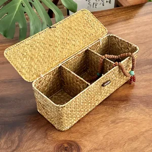 Hand-woven seagrass storage box with lid showing interior dividers for organization