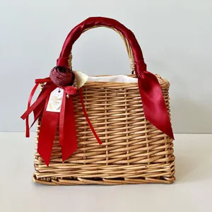 Elegant woven wicker gift basket featuring a red satin ribbon and floral thank you tag detail