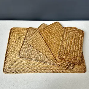 Handmade woven placemat detail shot, natural seagrass heat insulation pad for dining table.