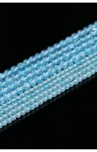 Detail macro view of natural blue topaz round beads in aquamarine color for DIY jewelry
