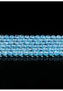 Detailed macro view of translucent light blue topaz round beads for DIY jewelry making