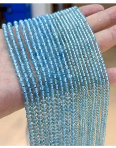 Detailed macro view of translucent light blue natural topaz round beads for DIY jewelry making