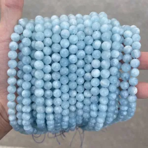 Close-up detail of natural light blue round topaz beads for DIY jewelry making
